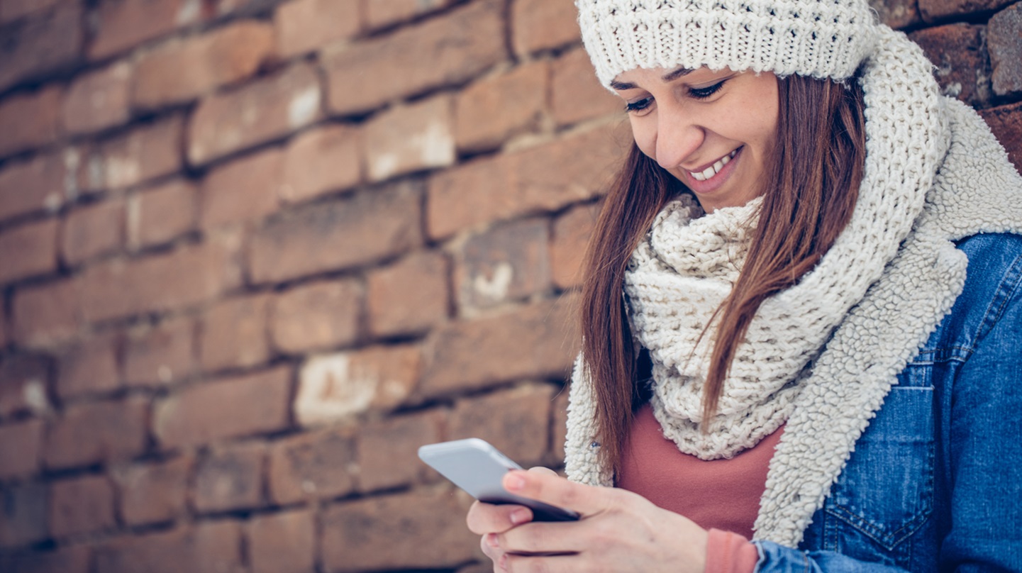 Junge Frau schaut auf ihr Handy